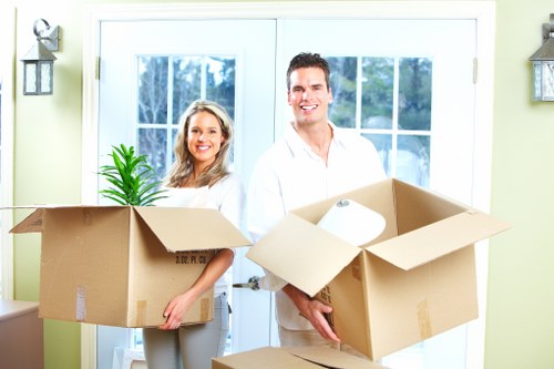 Professional movers handling furniture for a Canary Wharf flat removal