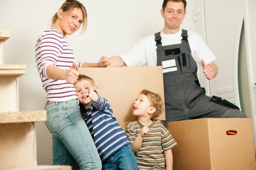 Professional movers carrying office furniture in Canary Wharf